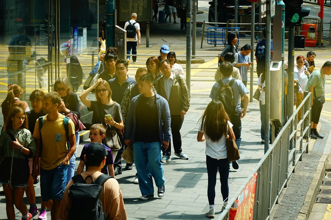 Crowd of pedestrians walking on a busy city street