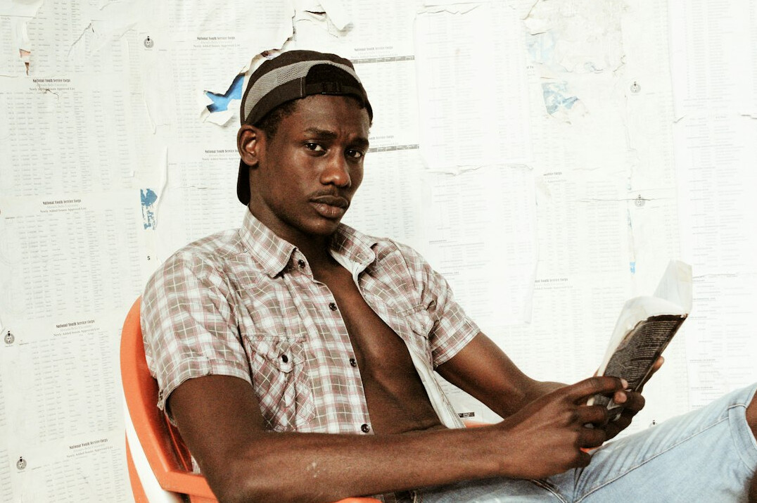 Studio portrait of a young Turkish man holding a notebook